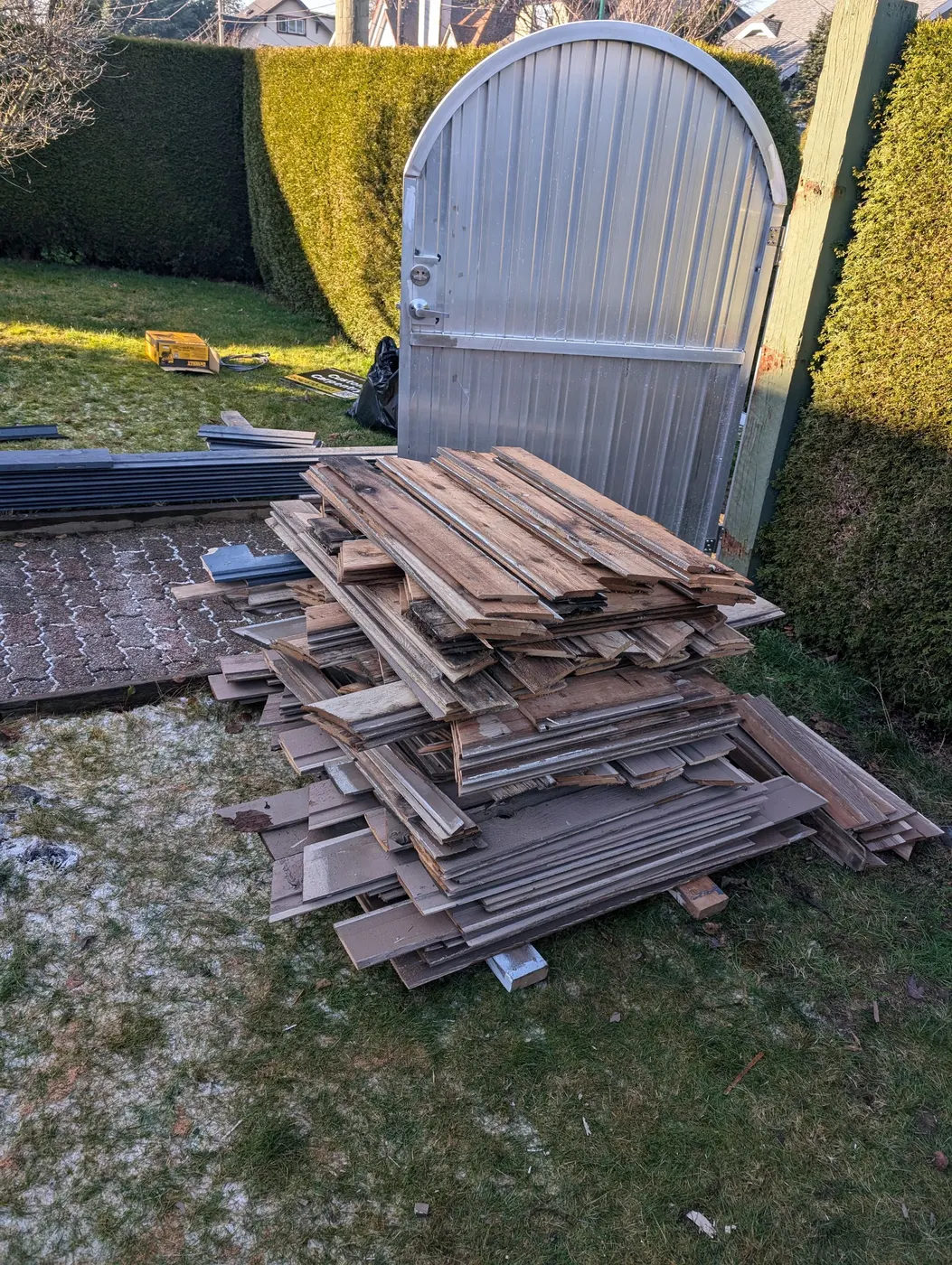 Pile of old wood siding and trim removed from a Vancouver home during an exterior carpentry and painting project.