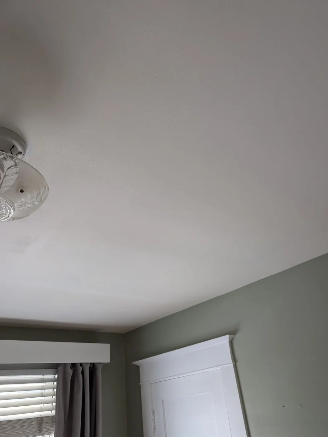 Smooth, crack-free ceiling after plaster repair and paint in a Vancouver bedroom