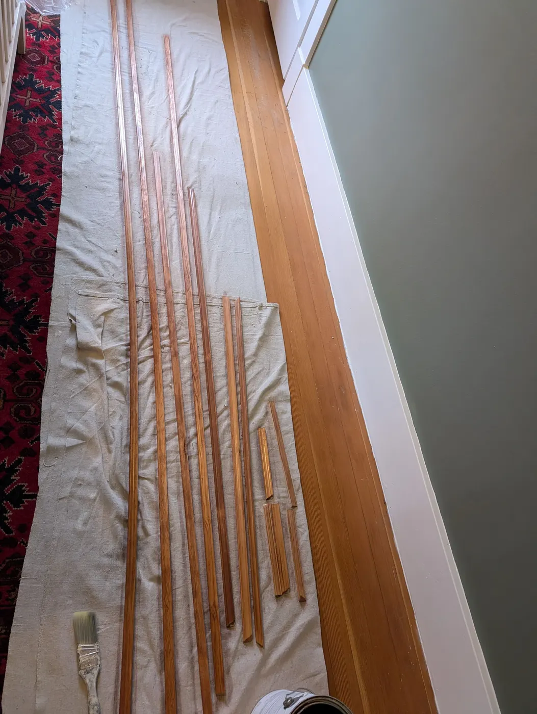 Freshly stained wood trim and casing pieces laid out for installation in a Vancouver, BC home