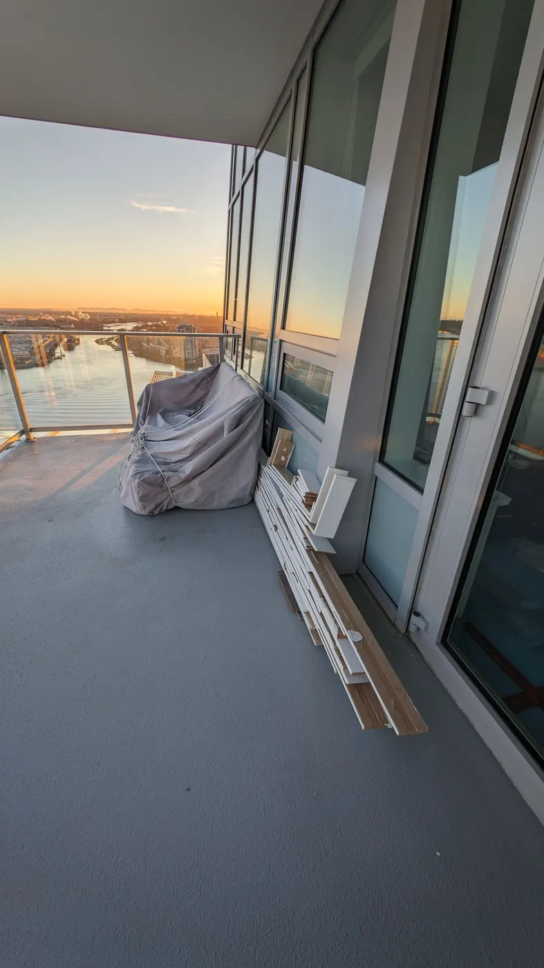 Cut baseboard and trim offcuts staged on a high-rise balcony during a Vancouver condo renovation.