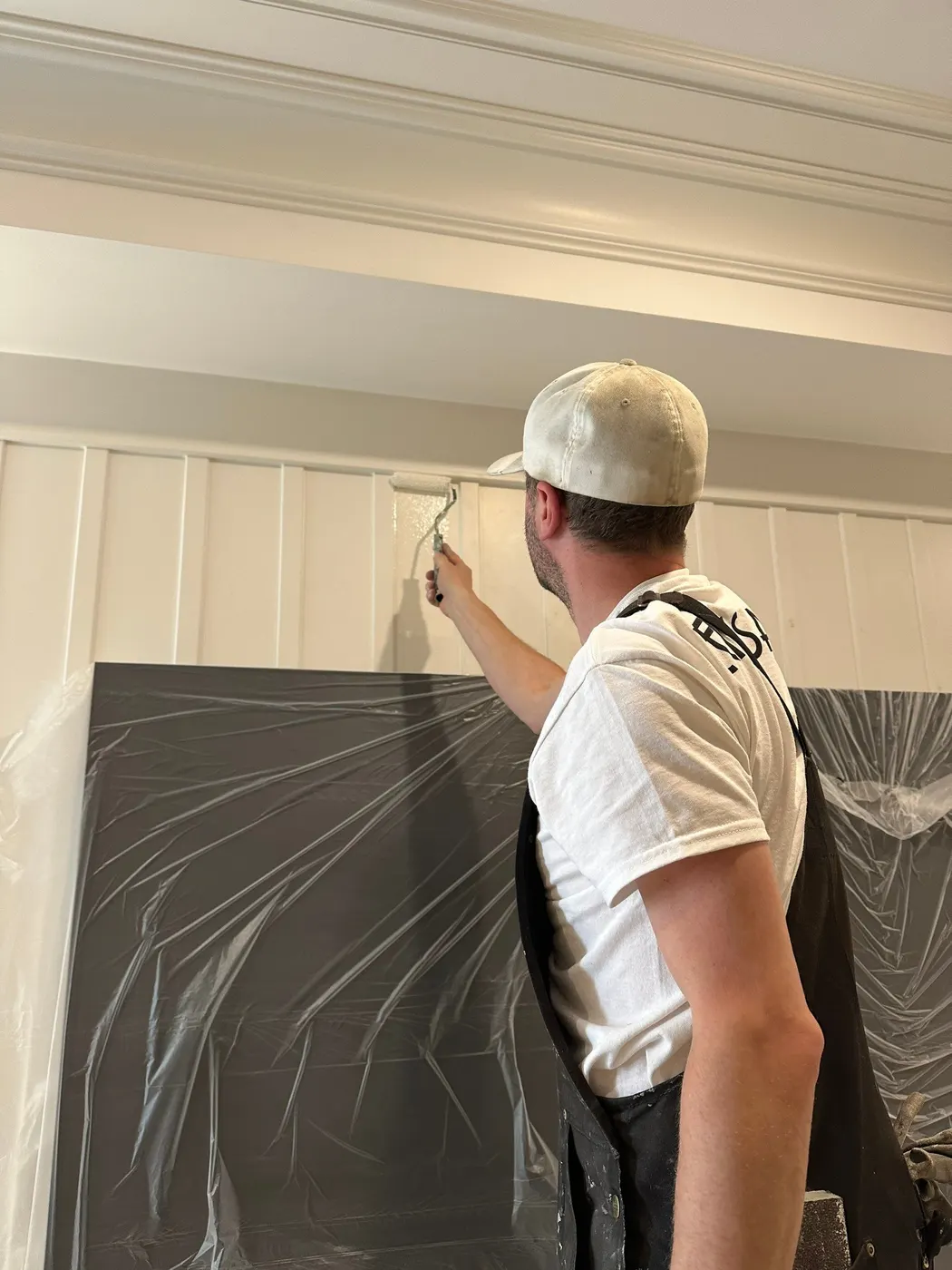 Freshly painted white wainscoting and trim in a finished basement living room in Beechwood, Vancouver, BC.