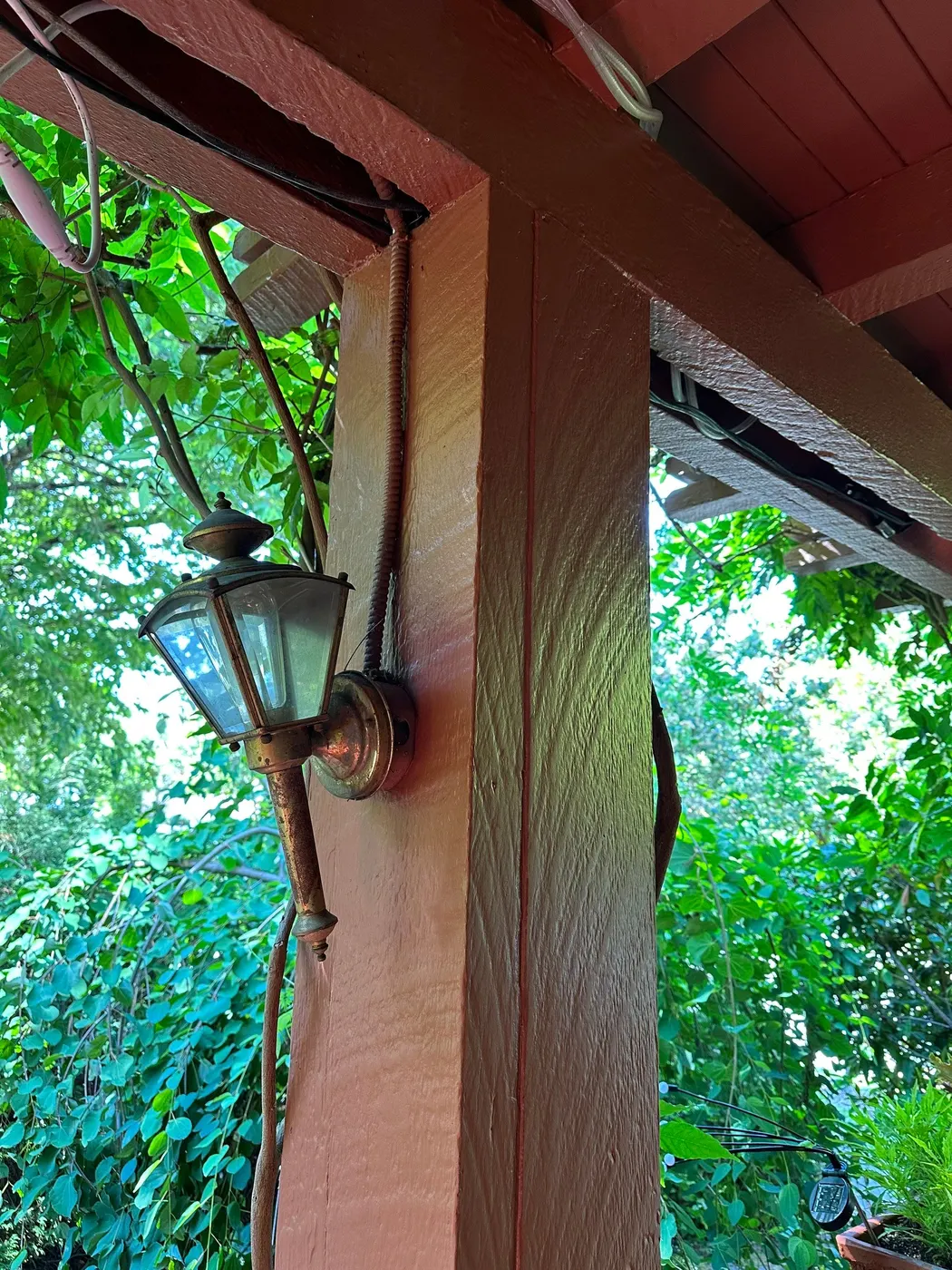 Vintage porch light fixture mounted on a freshly painted post on a Vancouver home