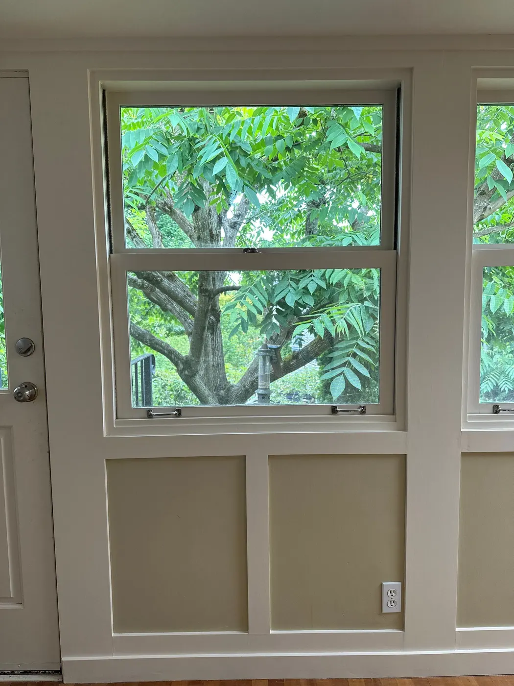 Freshly painted window trim and wainscoting panels in a Vancouver home interior.