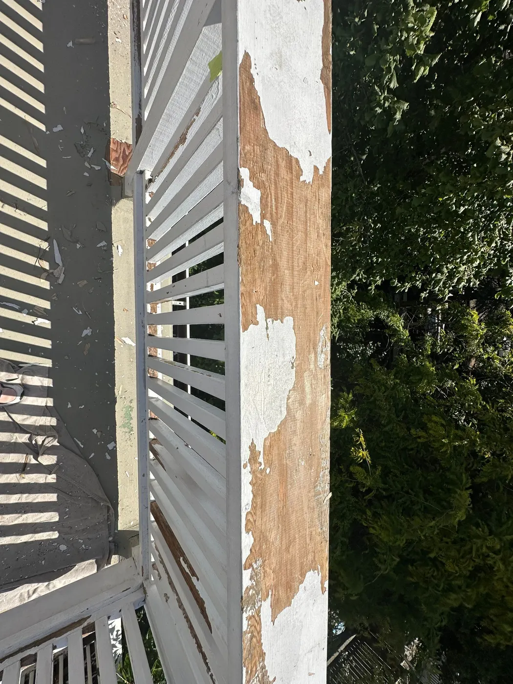 Severely rotted deck corner post exposing bare wood on a Vancouver home before repair