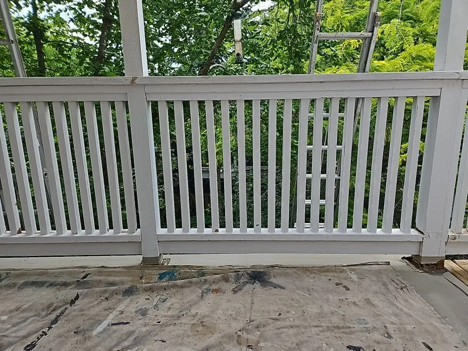 Freshly painted white deck railing overlooking greenery on a Vancouver, BC home after repair