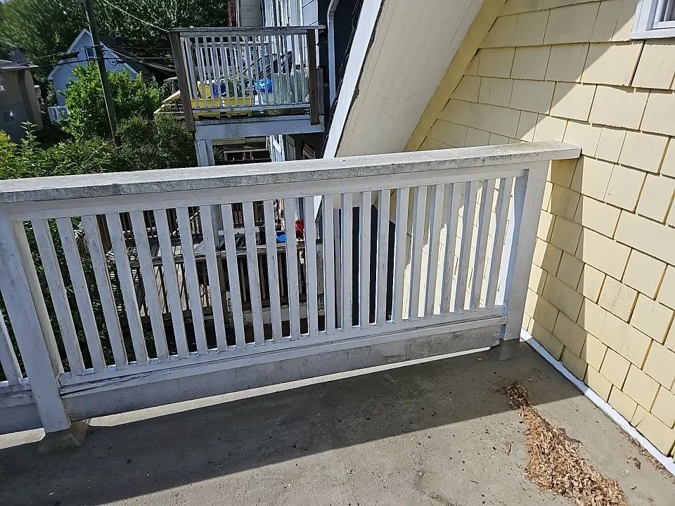 Weathered white deck railing before repair on a Vancouver, BC home by Renaissance Painting