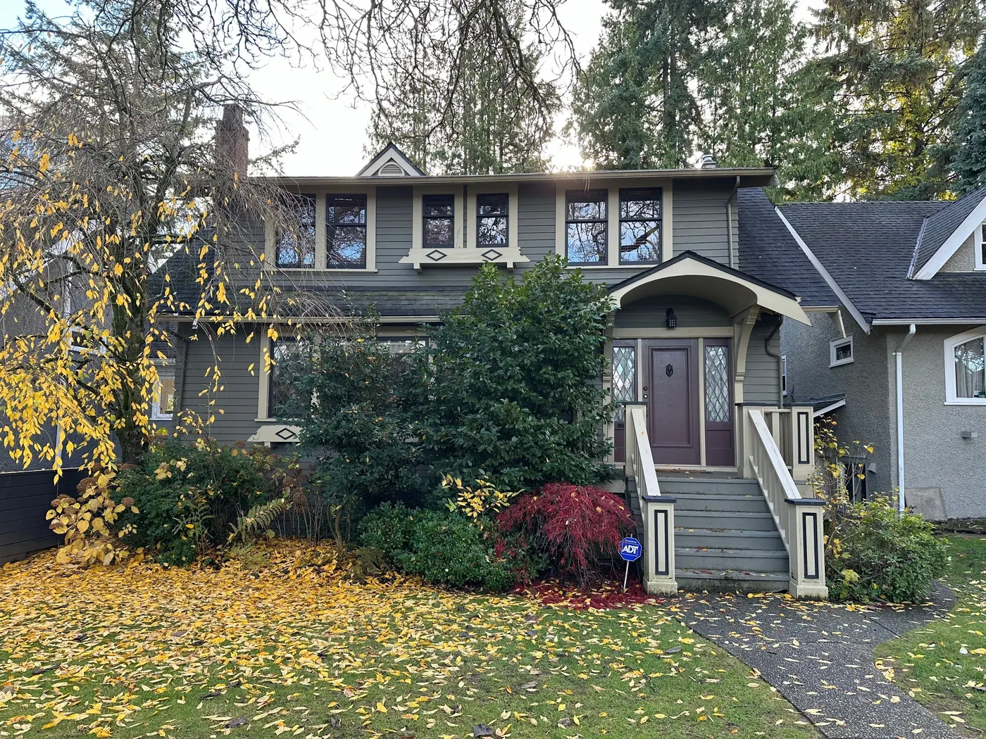 Sage green Craftsman house exterior with a maroon front door, painted by Renaissance Painting in Vancouver, BC.
