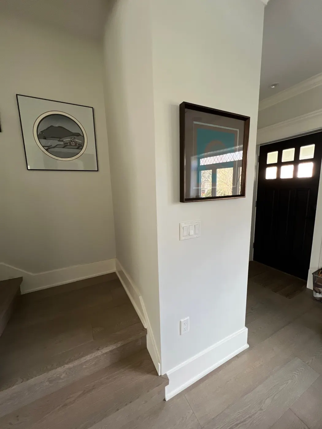 Freshly painted entryway trim, baseboards, and crown molding in a Vancouver, BC residence
