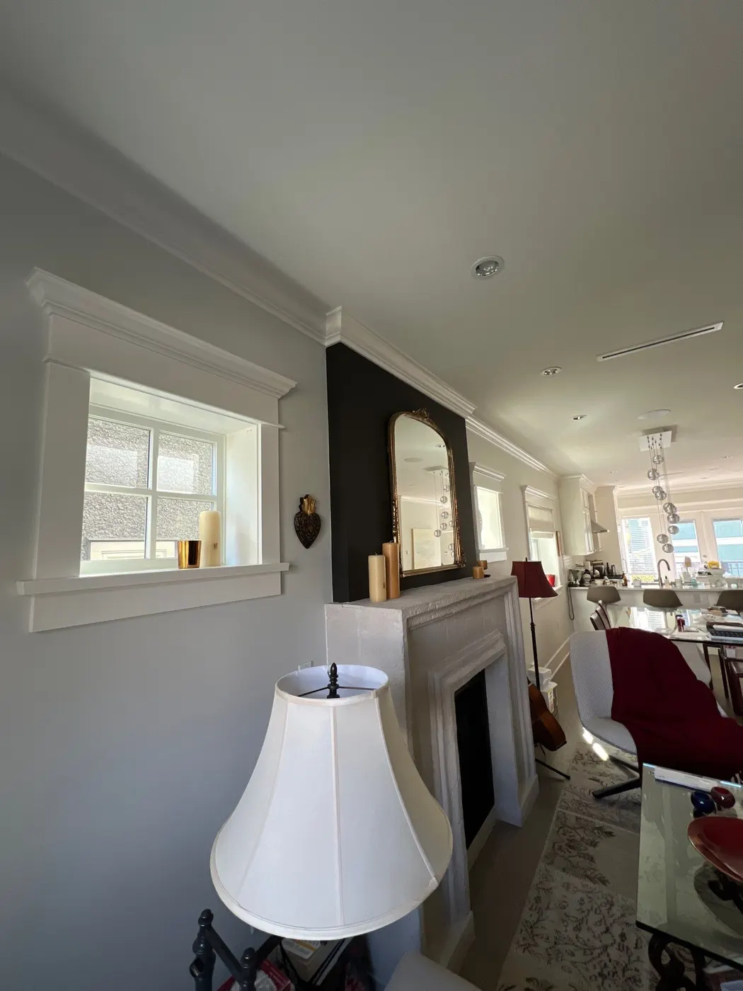 Living room with painted crown molding, trim, and fireplace mantel in a Vancouver, BC home