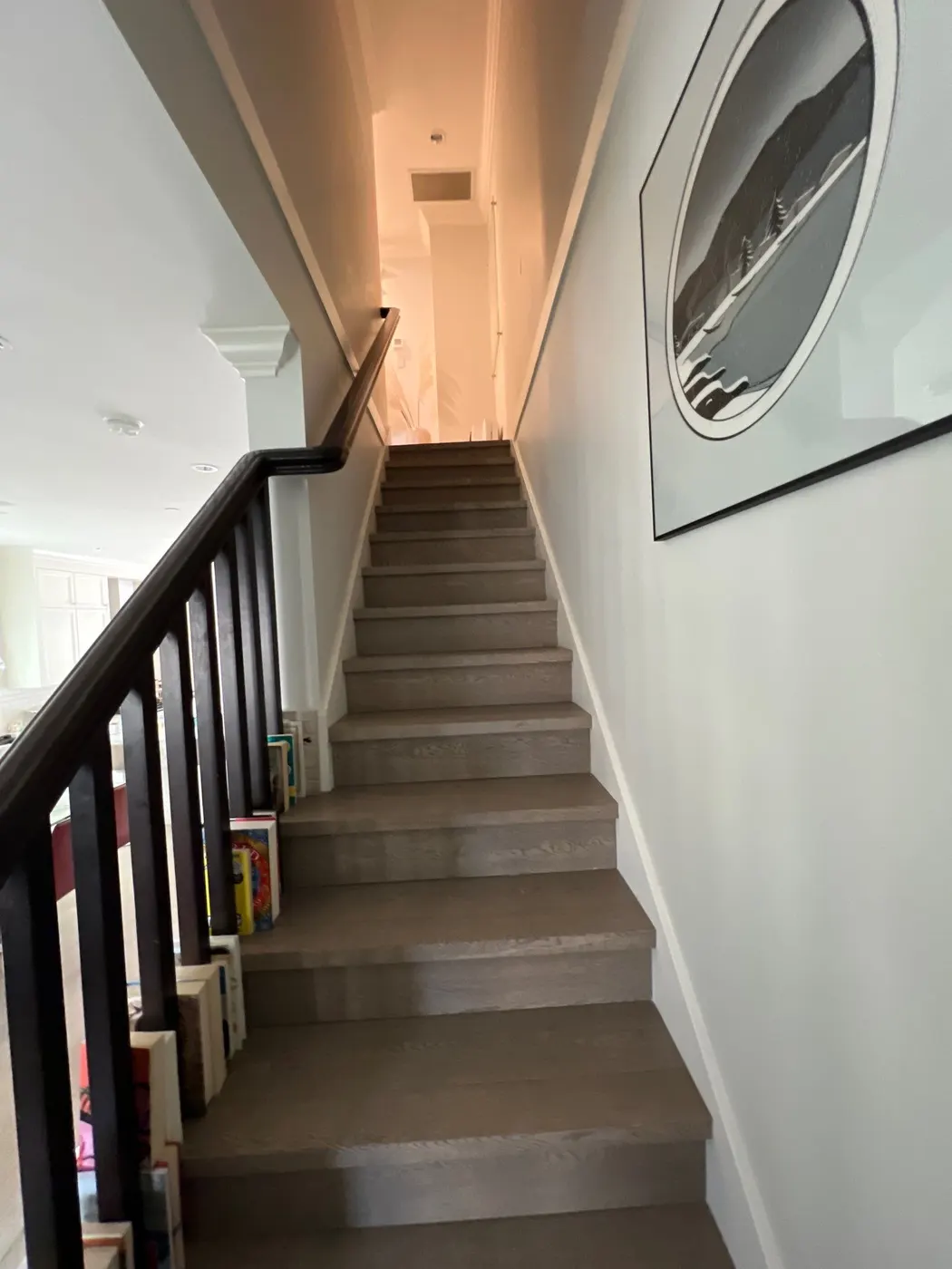 Staircase with freshly painted walls, trim, and crown molding in a Vancouver, BC home