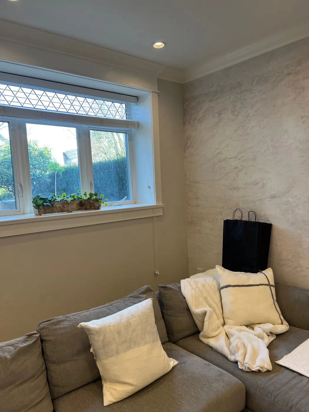 Living room with a custom textured accent wall and freshly painted trim and ceiling in a Vancouver, BC home