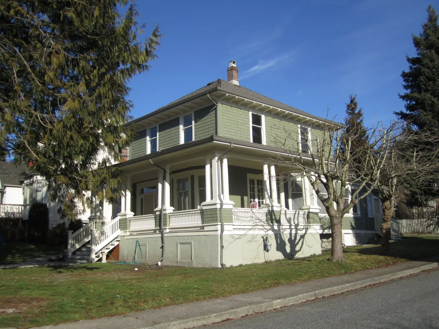 Freshly painted green and white character home exterior in Vancouver, BC after a professional house painting project