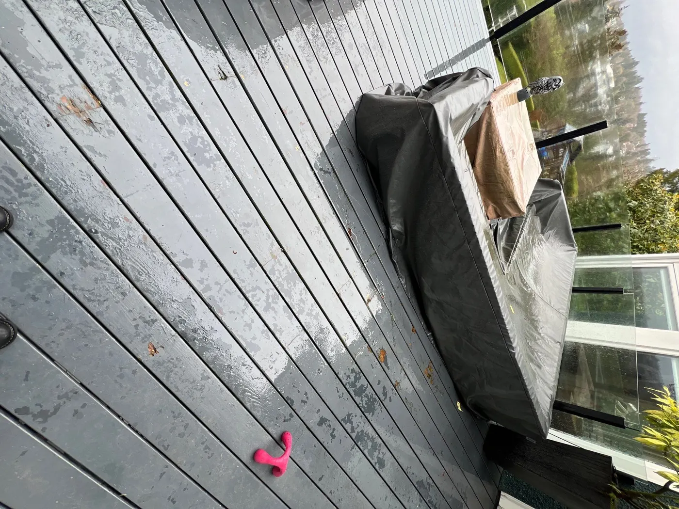 Weathered, peeling grey paint on wood deck stair treads at a Vancouver, BC home needing repainting