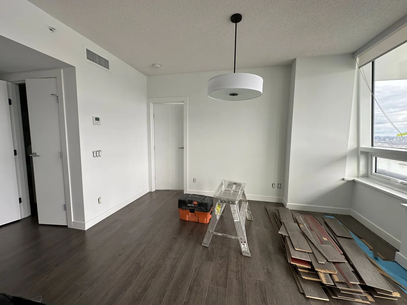 Condo room prepped with a ladder and flooring materials during a Vancouver, BC renovation