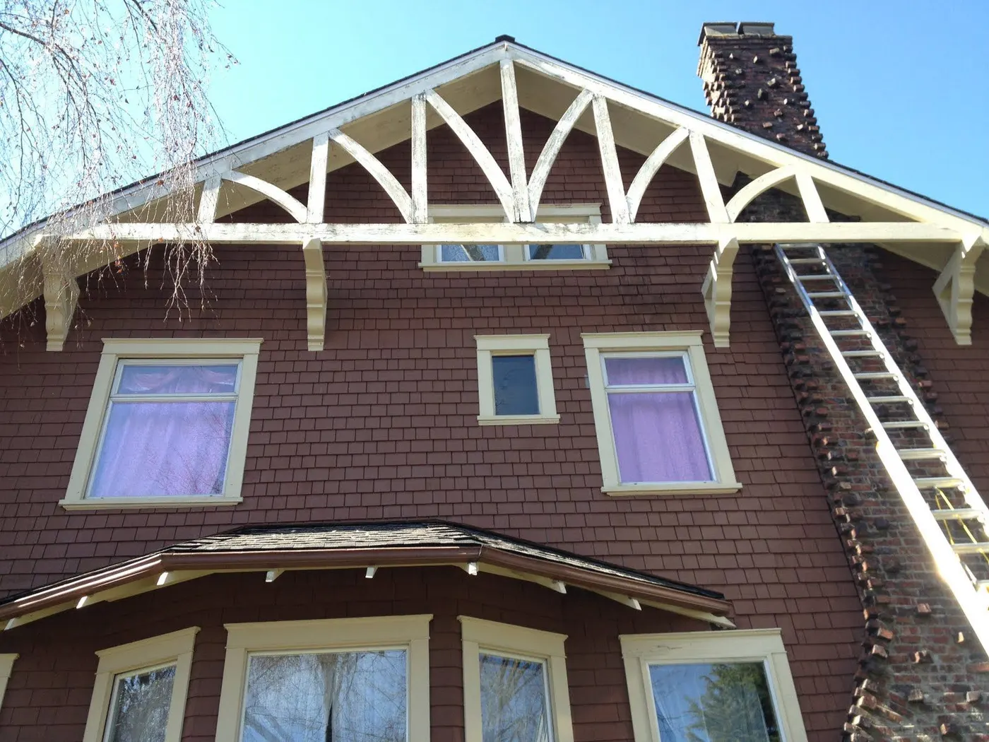 Restored decorative gable trusswork on a Vancouver, BC Craftsman home against a clear sky