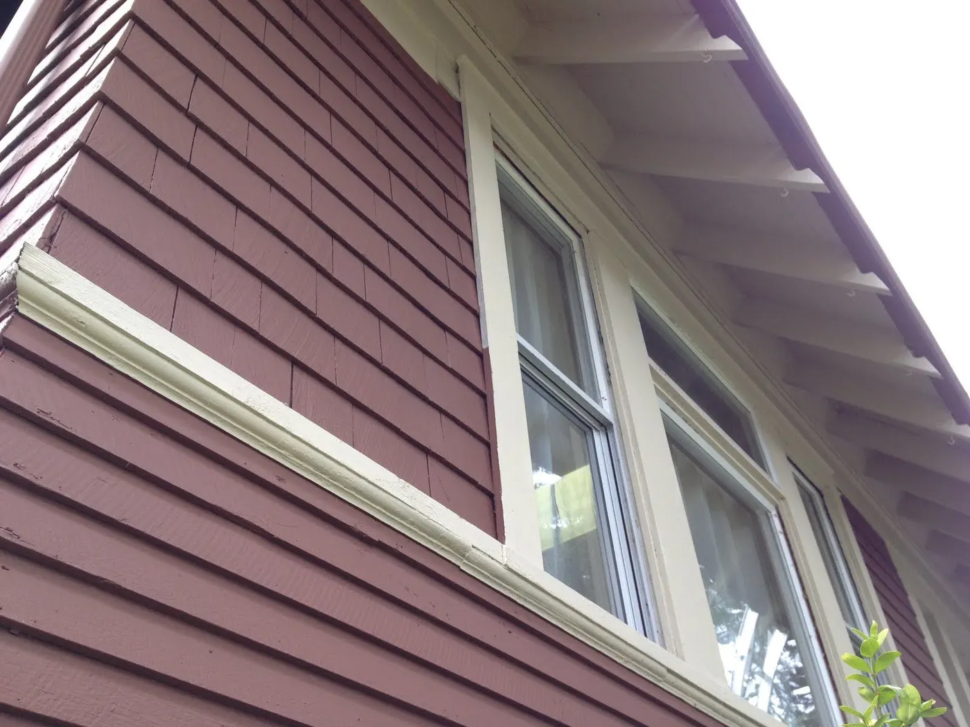 Close-up of new cedar shingle siding and cream trim on a Vancouver, BC home