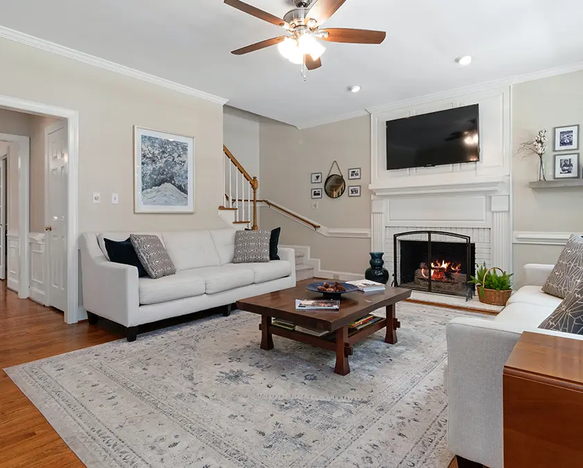 Modern living room with white paint on ceiling and off-white on walls, matching couches.