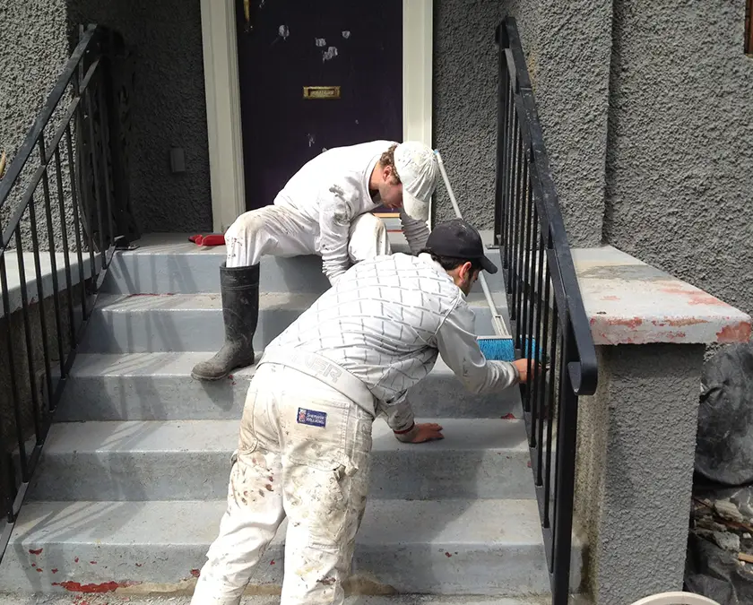 Team members painting exterior.