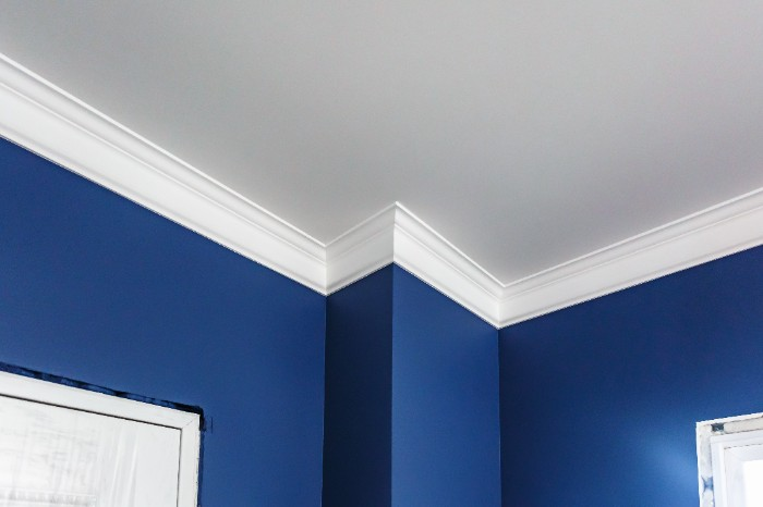 Use a light color on the ceiling to keep attention drawn towards any design elements such as crown moulding or baseboarding.