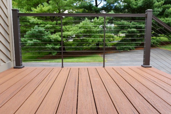 Stainless steel cable railing with aluminum posts and composite boards for the deck.