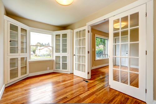 French doors and built-book cases. Crown molding would help finish this room.