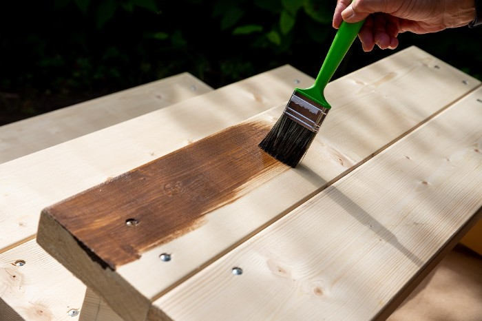 Applying stain to exterior stairs. These boards should have been stained on all six sides before installing. deck, exterior, exterior stairs, outdoor stairs