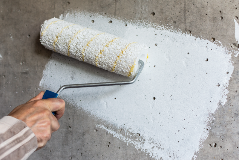 Concrete surfaces will need one coat of primer to seal the porous