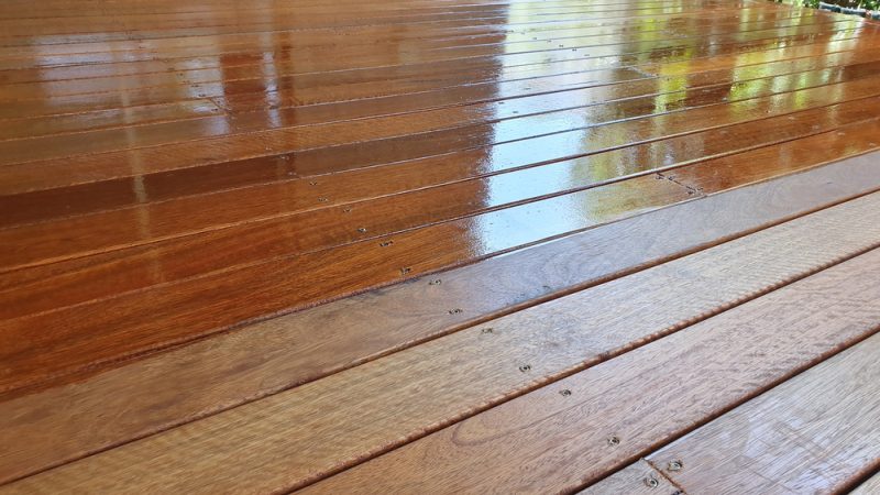 Wooden deck staining half stained.