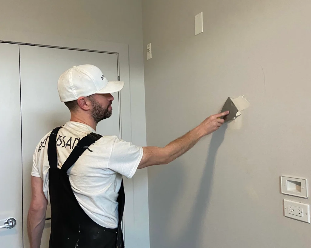 fad4ab66-2658-4d4b-8b57-447cb1b7c44e - Renaissance Painting An image showing a professional painter preparing a wall surface for painting