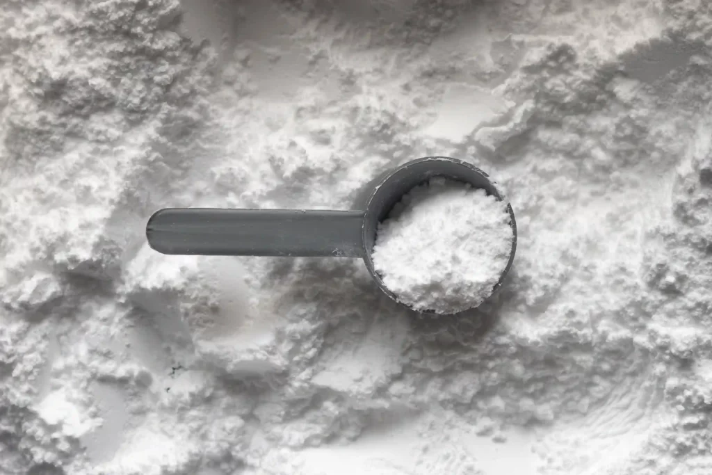 Baking soda, aka sodium bicarbonate with a grey scoop inside. 