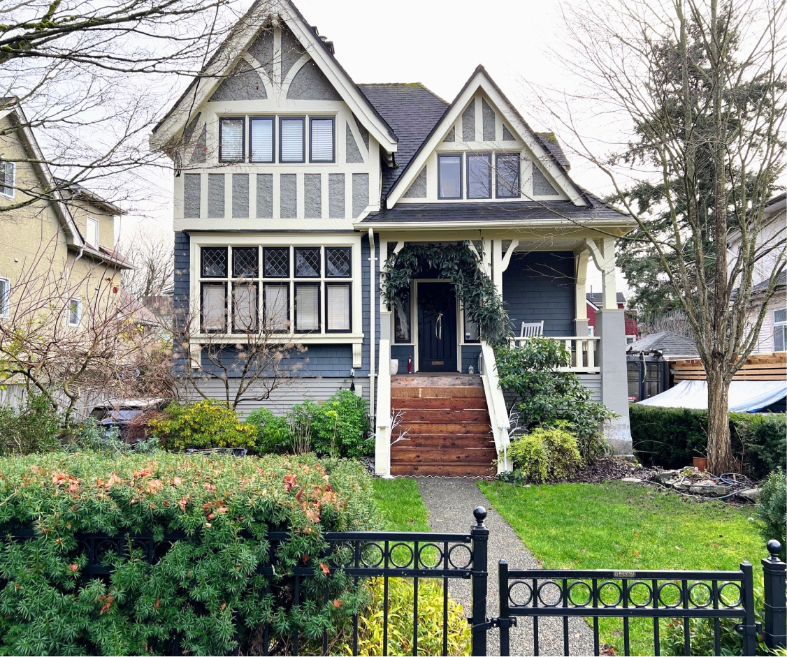 Vancouver exterior painting on a restored heritage home with crisp trim and natural wood steps, finished in a professional style.
