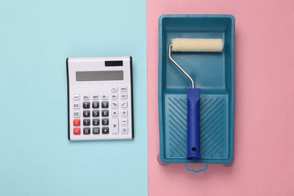 Calculator on the left and a painting tray and a roller on the right.