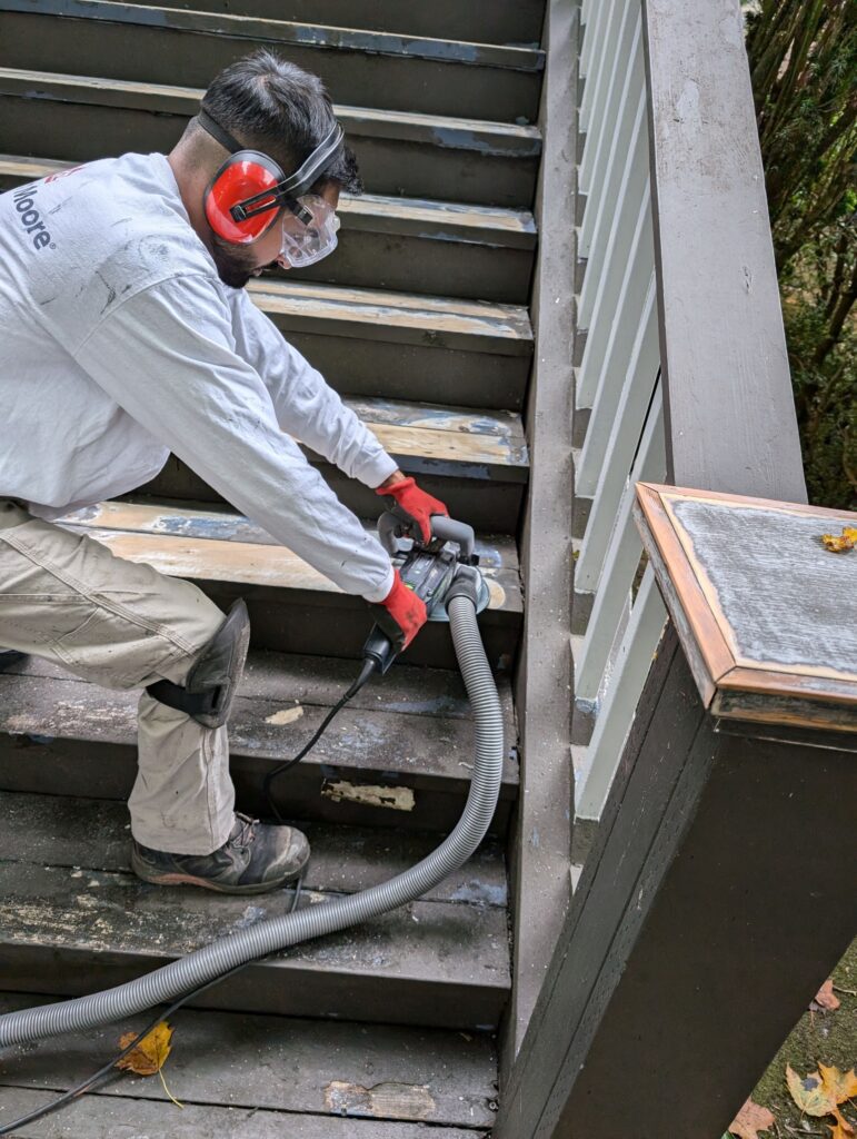 Jag removing 20 layers of paint on front stairs. He is using a Festool grinder.