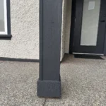 Painted porch column with black trim and entry door as part of exterior trim renovation