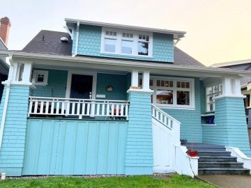 Vancouver exterior painting showcasing a freshly painted blue heritage home with crisp white trim and a clean, professional finish.