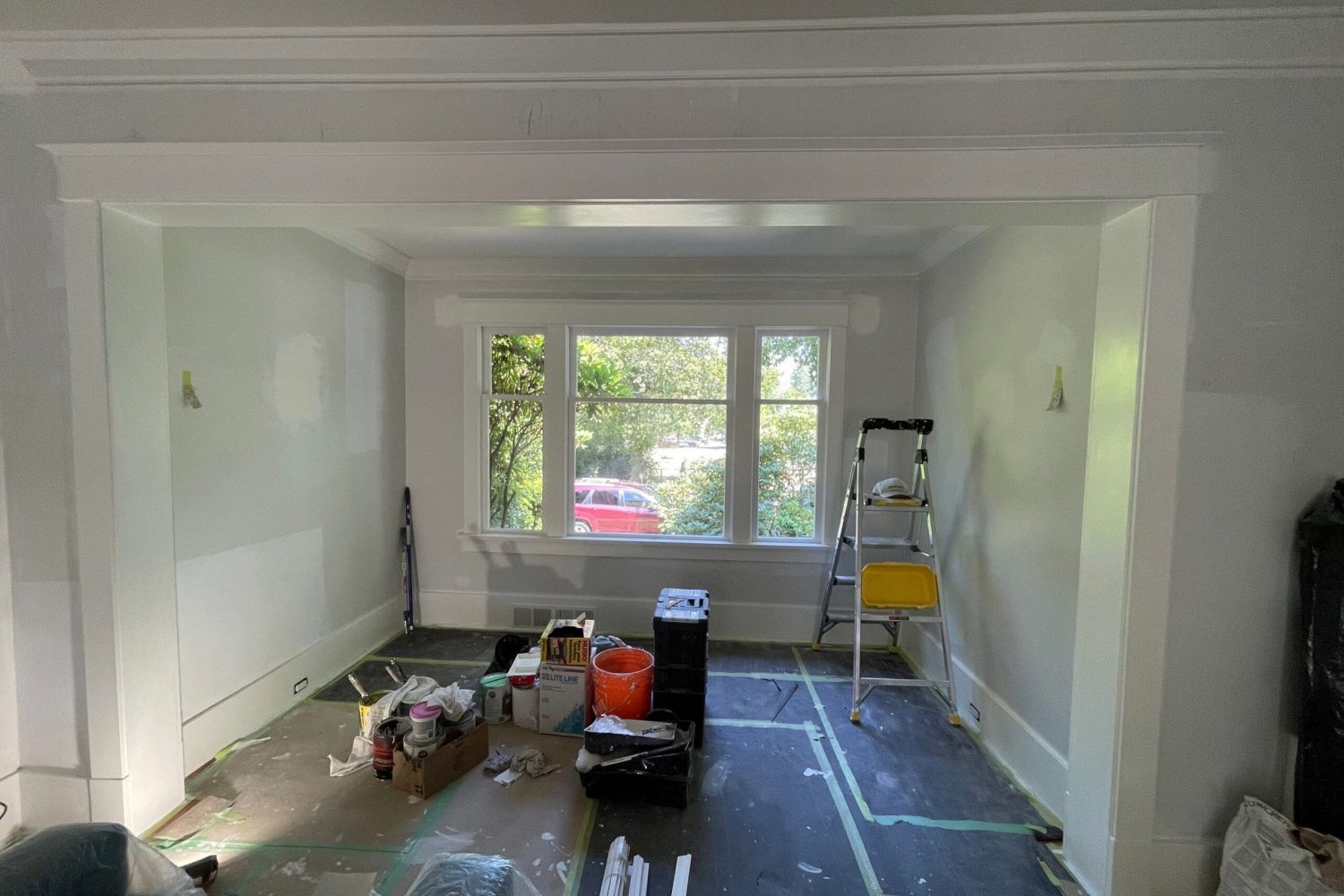 Room with walls prepared for crown molding installation, professional trim work