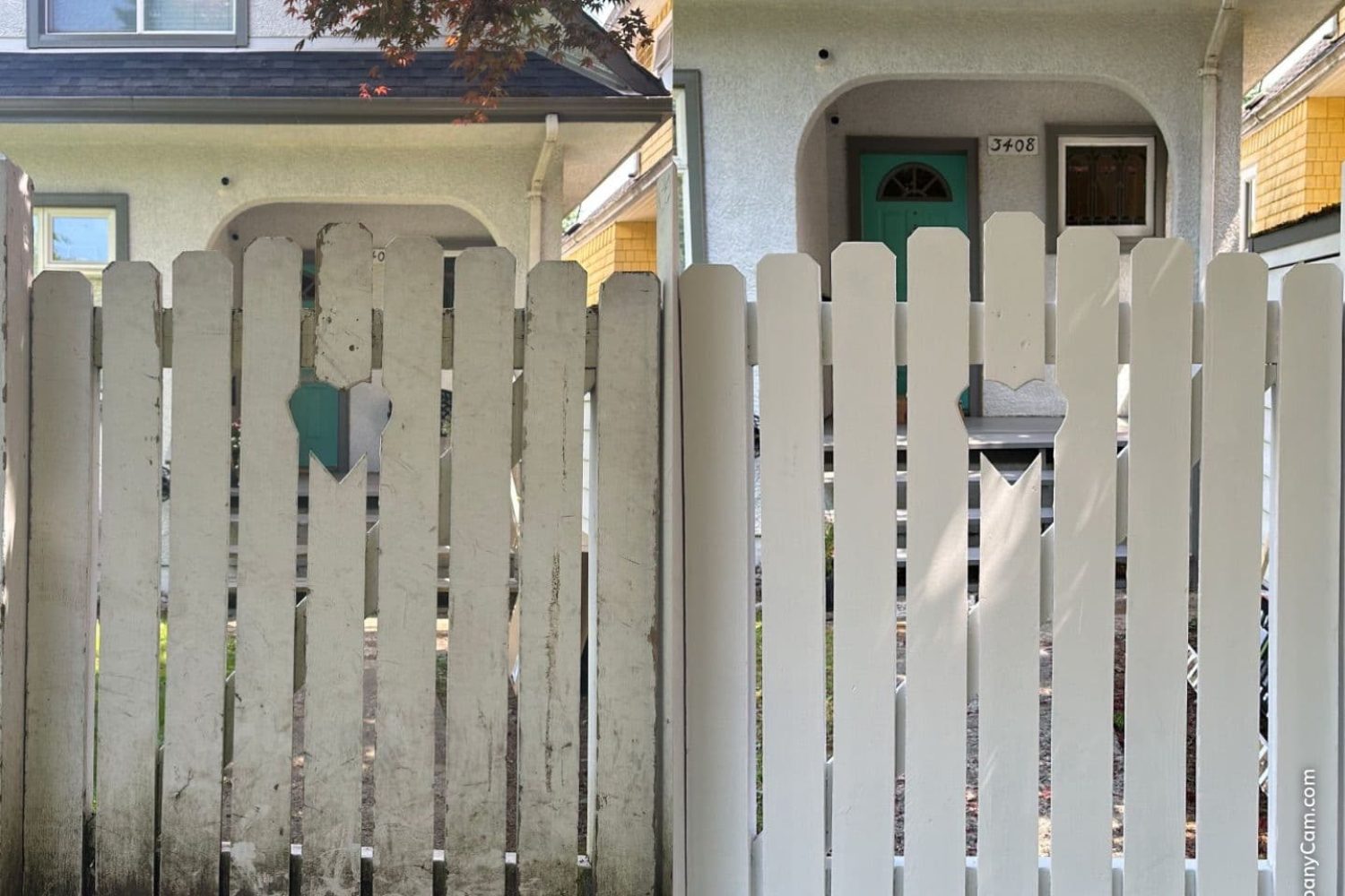 White fence with green door, maintenance completed to fix damaged boards