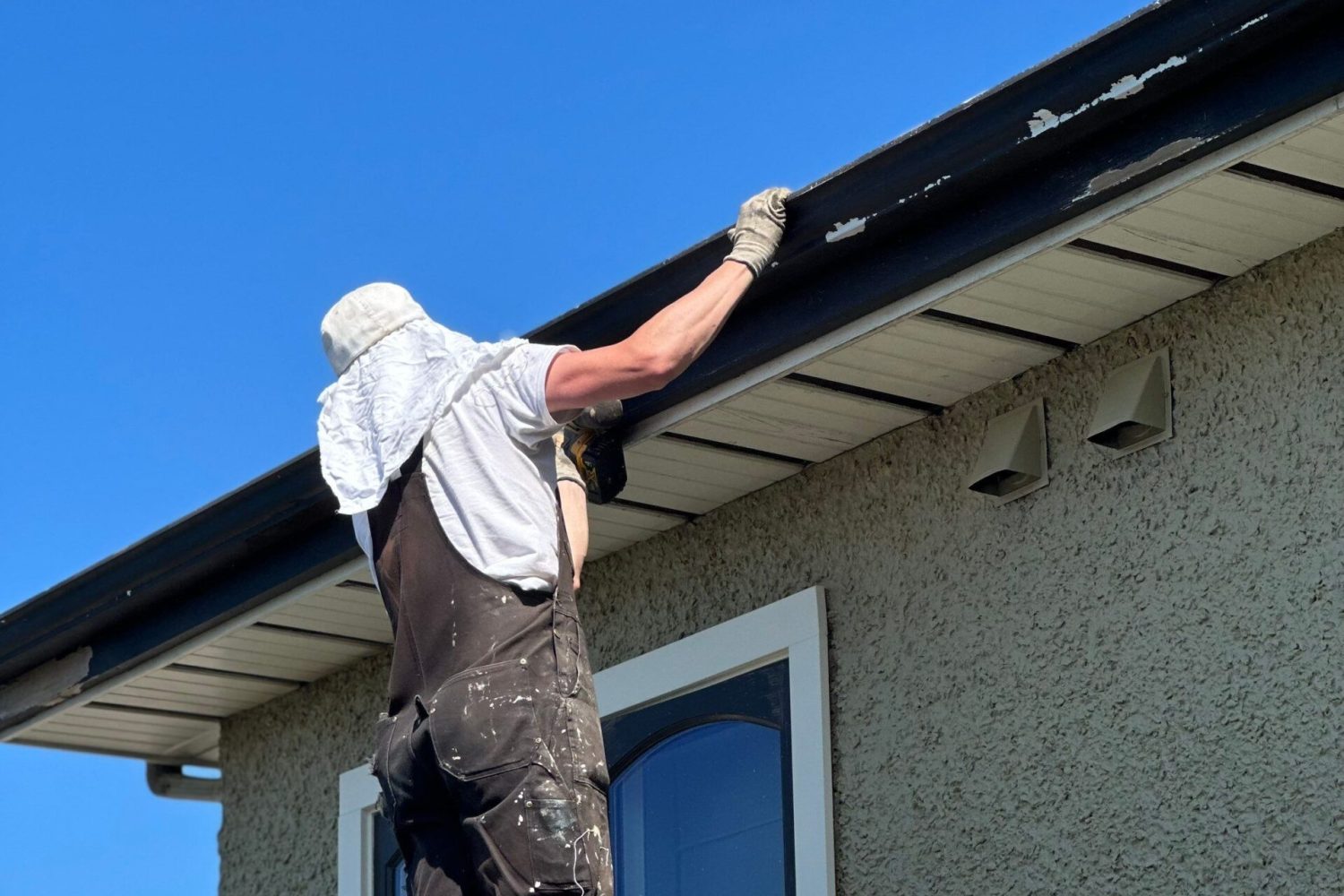 A crew member is exploring a roof and a gutter.