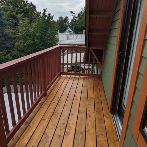 Wooden deck with green and brown siding, custom deck installation