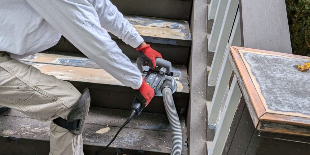 Jag removing 20 layers of paint on front stairs. He is using a Festool grinder.