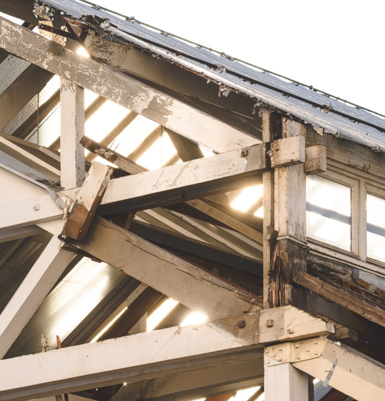 Rotten wooden roof beams in Vancouver home, showing structural damage and in need of professional wood beam repair and reinforcement